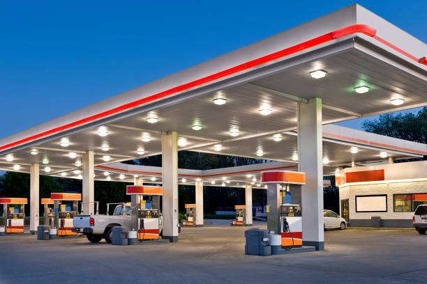 Person filling car at petrol station